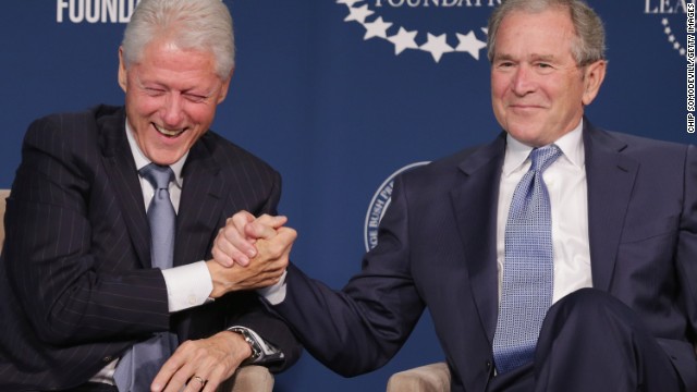 George Bush shakes hand with Bill Clinton