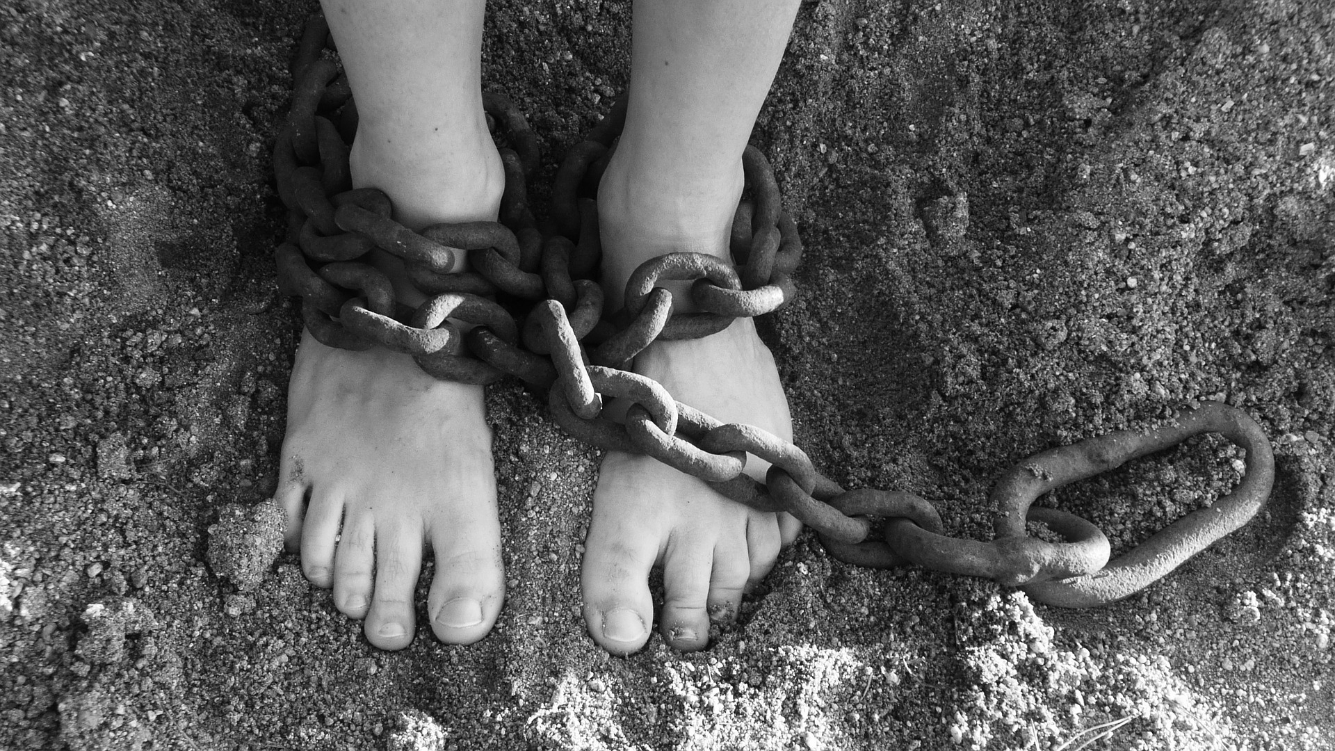 Slavery with chains around feet, bondage