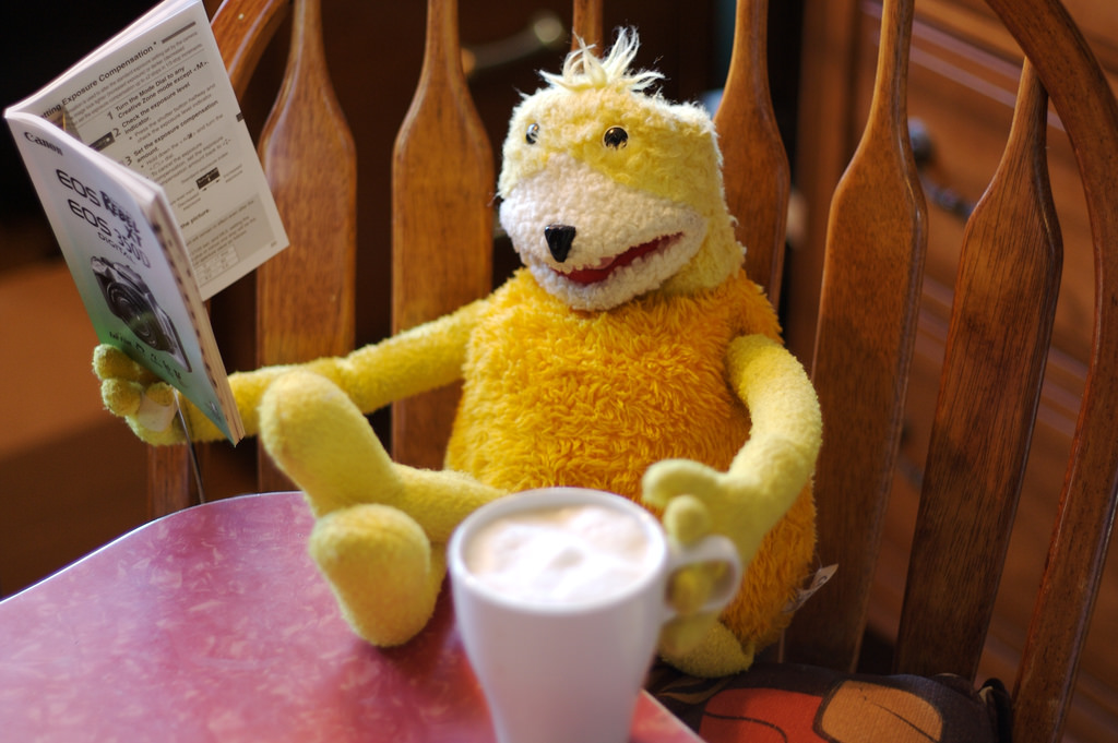 Cool yellow puppet: Flat Eric (Mr. Oizo)( drinking coffee and reading newspaper
