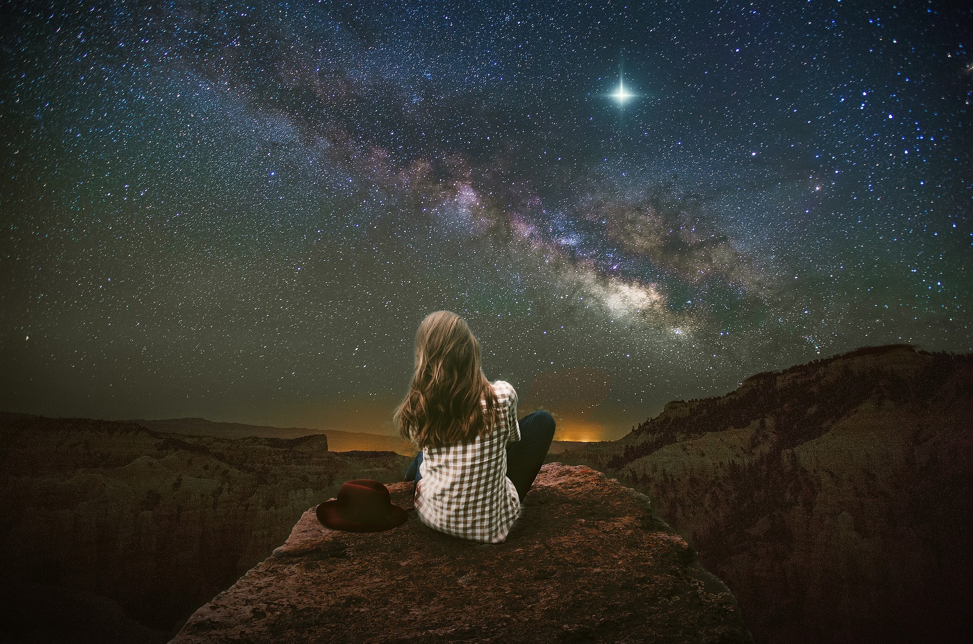 Girl looking into stars and the universe, landscape