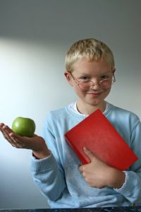 Boy with apple and book.