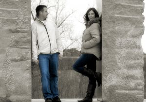 Couple standing at walls. 