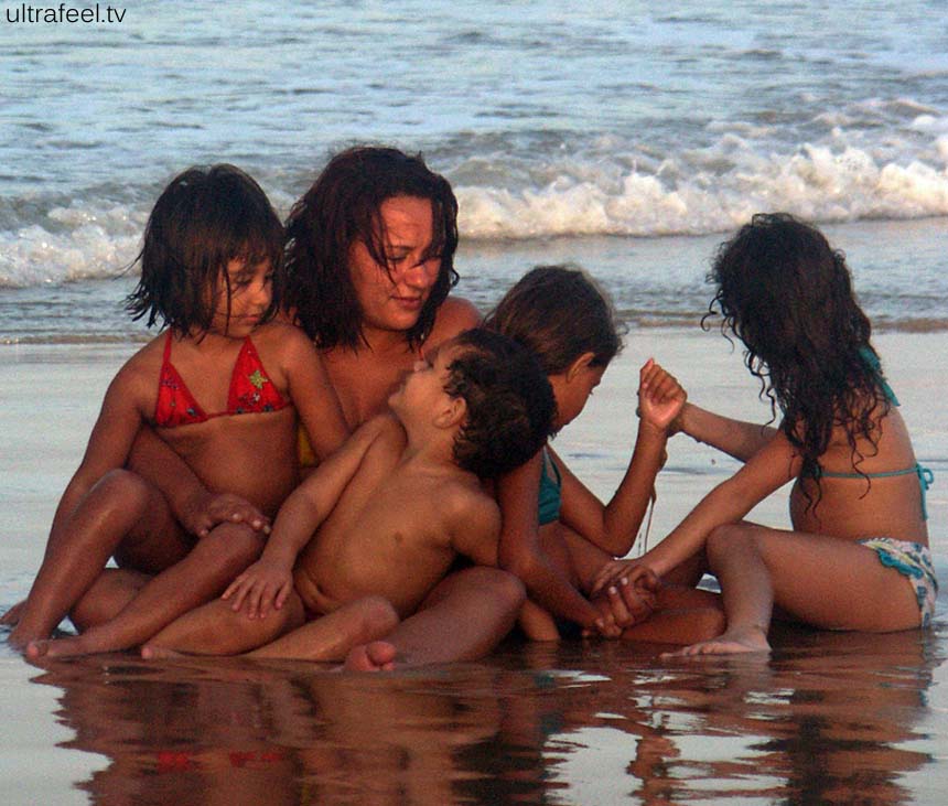 Mother with their children on beach.