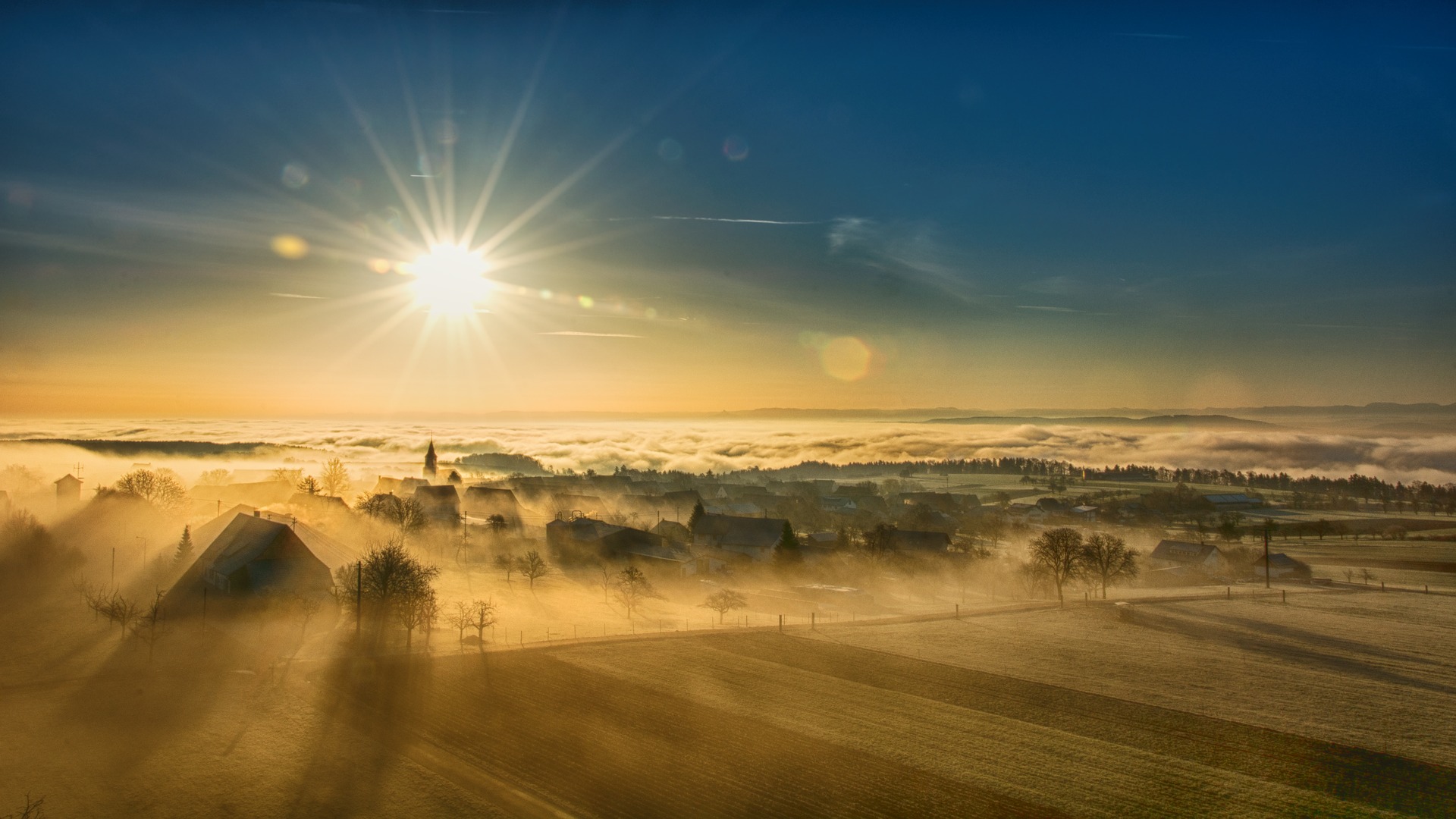 Sun rays on foggy landscape