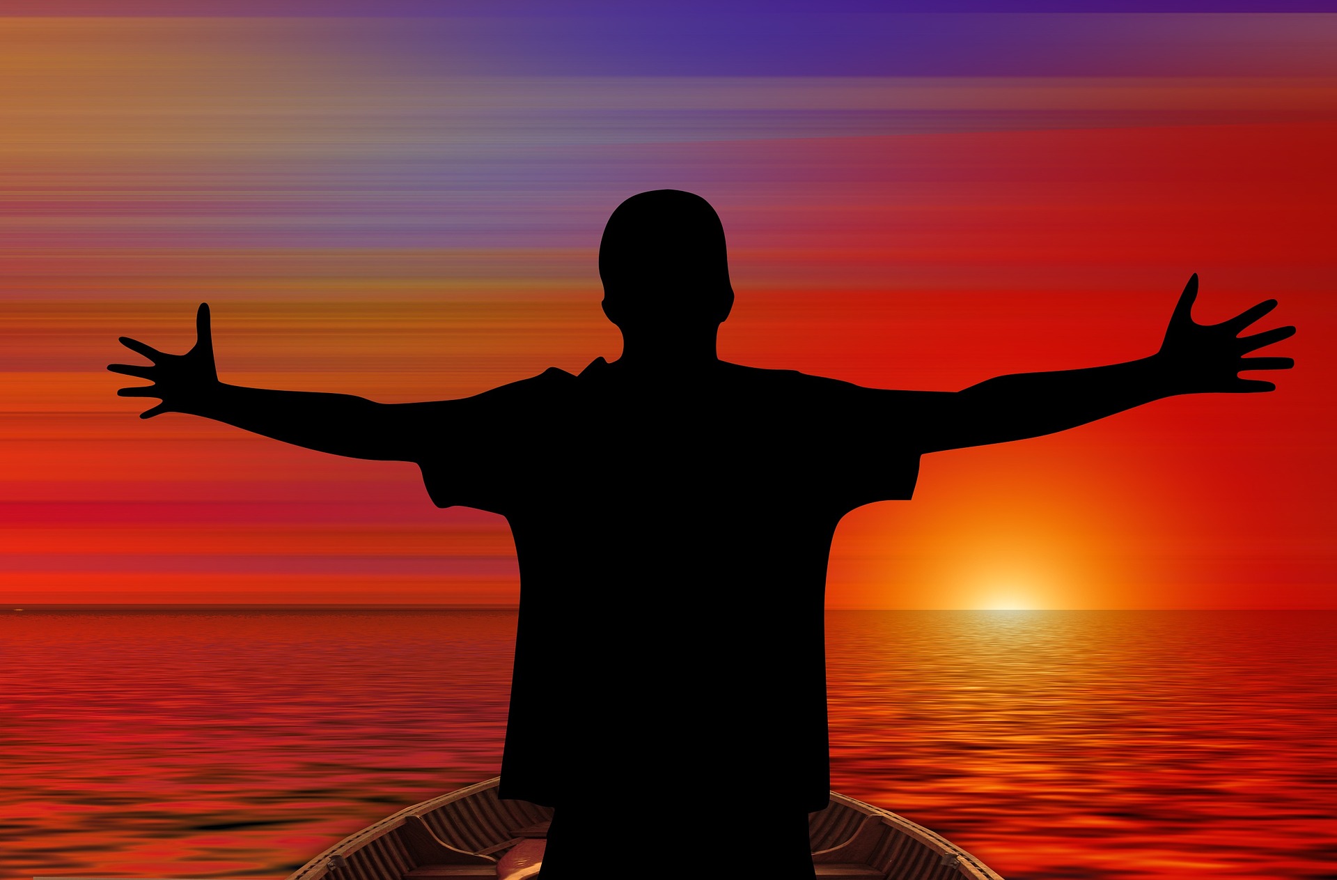 Man on boat welcoming sunrise with open arms