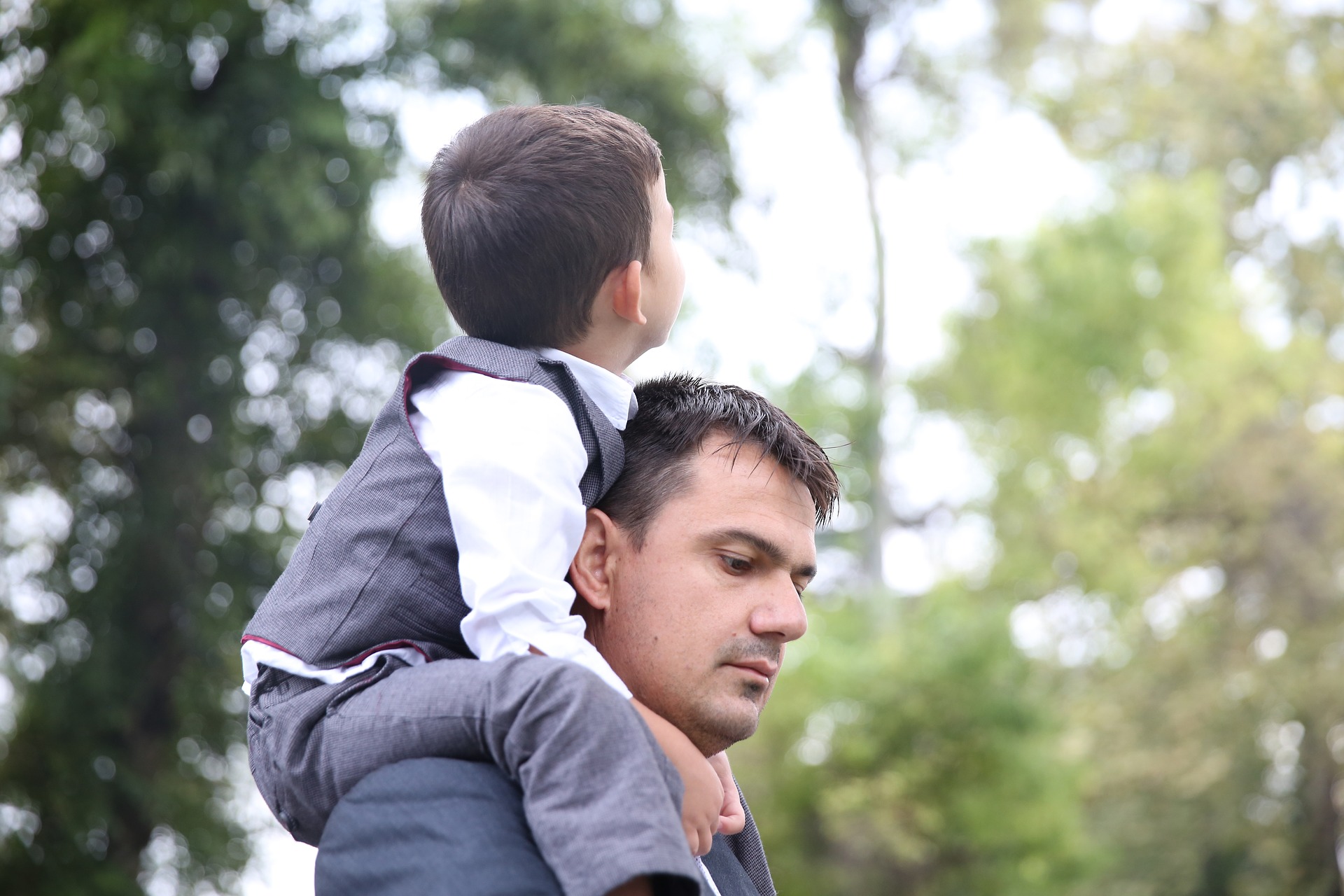 Son sitting on father's shoulders