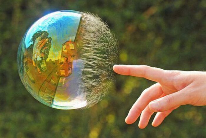 water bubble burst with finger