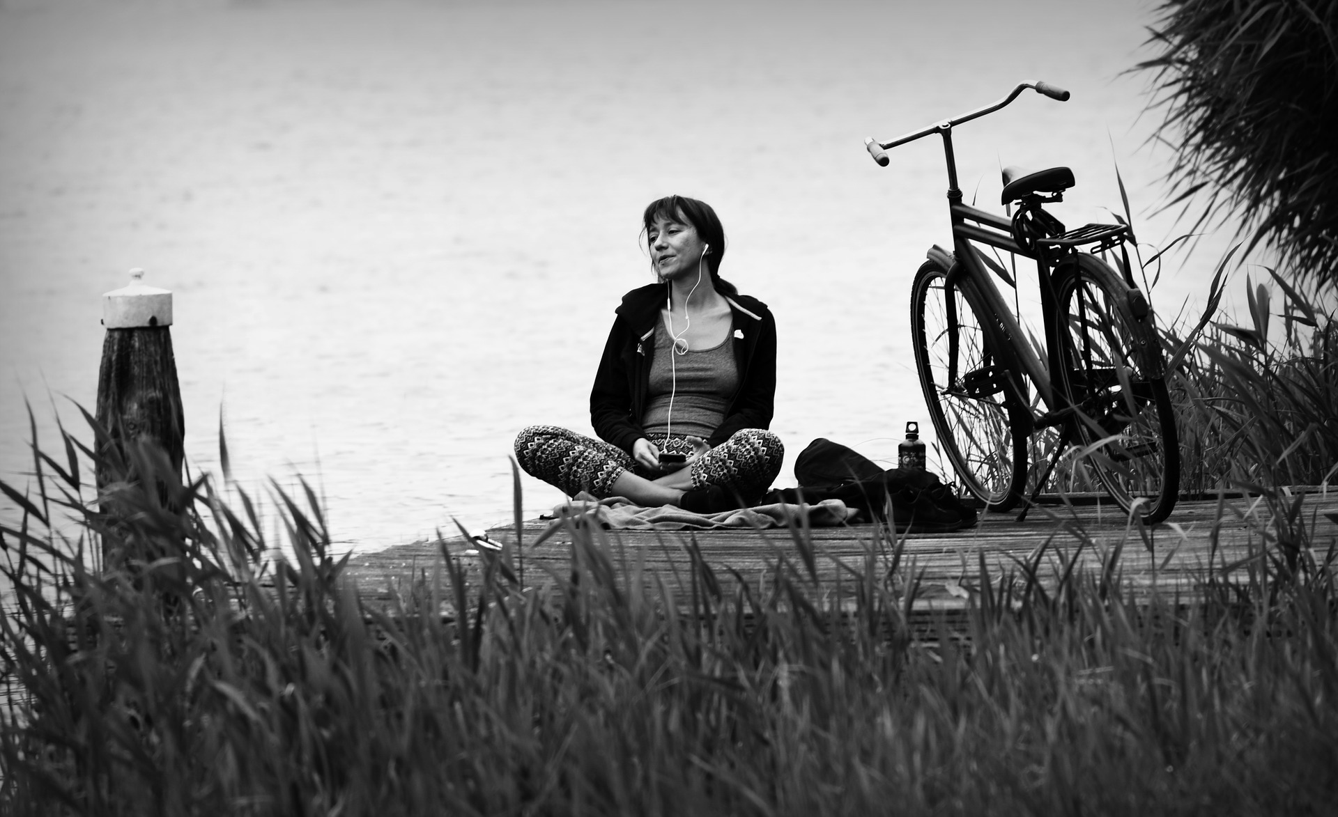 Woman: Meditation at the lake with bicycle