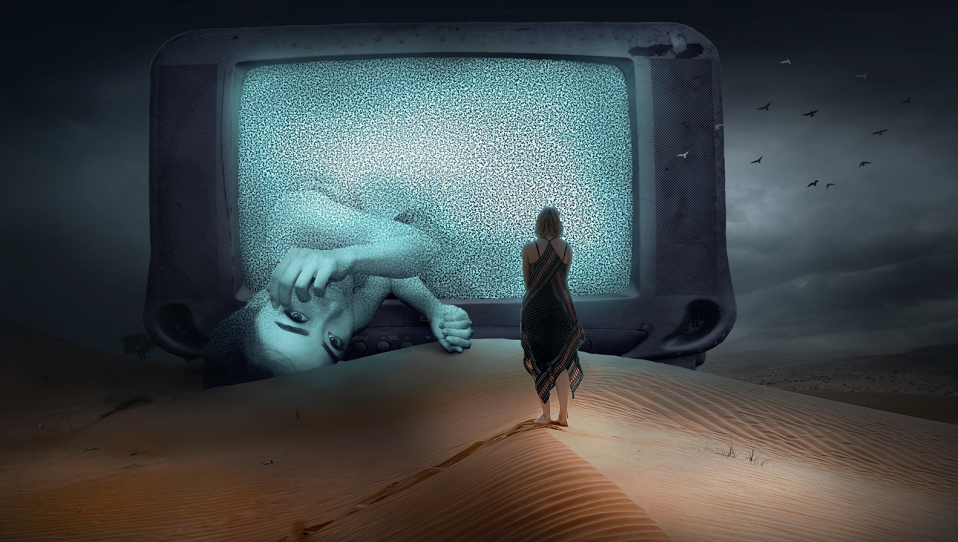 Dreamy scence: Woman walking on desert-sand into huge TV